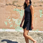 Woman standing in the sand wearing Black Clover Live Lucky hollywood hat in black.